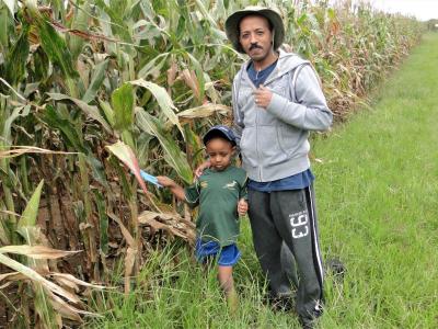 Dr. Girma T. Kassie with his son in the field